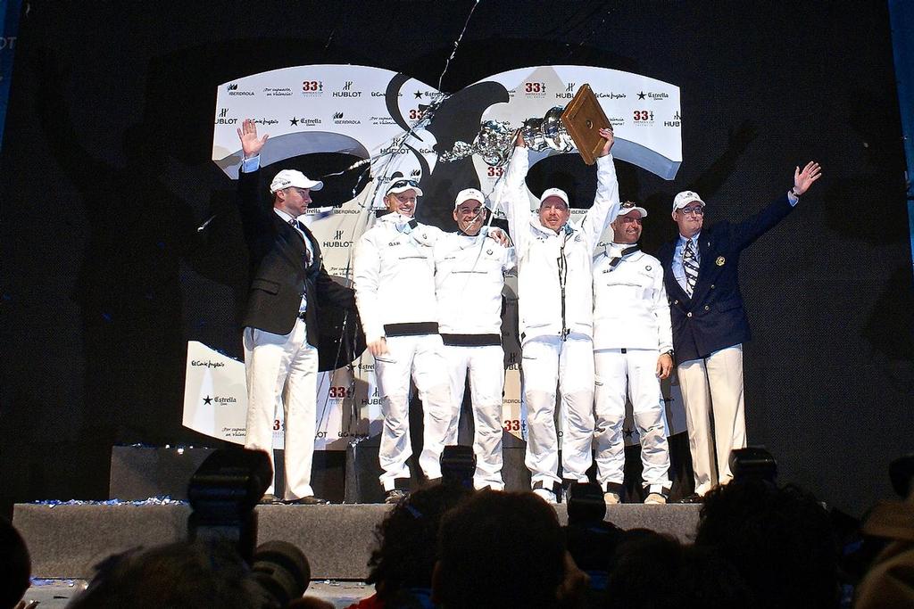 Russell Coutts, Larry Ellison, Jimmy Spithill and John Kostecki hold the America’s Cup high in Valencia in February 2010 as GGYC Commodore Marcus Young (left) looks on with Norbert Bajurin (GGYC current Commodore). © Richard Gladwell www.photosport.co.nz